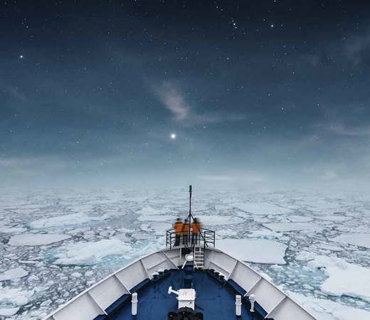 A ship sailing in icy water